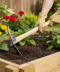 Gardener using Heavy Duty 2 In 1 Garden Hoe And Pickaxe With Wood Handle in planting bed
