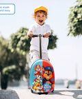 Front view of a child riding a Paw Patrol ride-on suitcase scooter with light-up wheels and blue-red character print