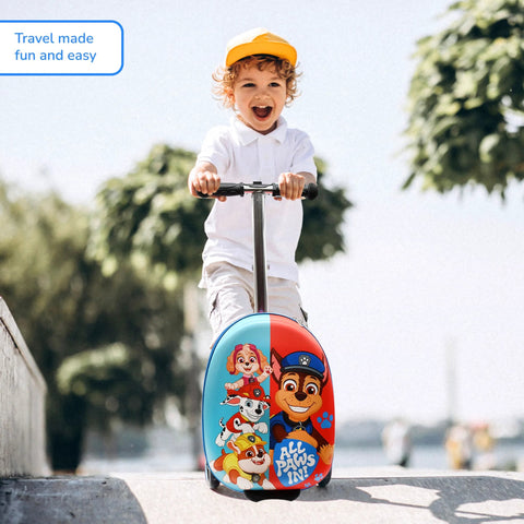 Front view of a child riding a Paw Patrol ride-on suitcase scooter with light-up wheels and blue-red character print