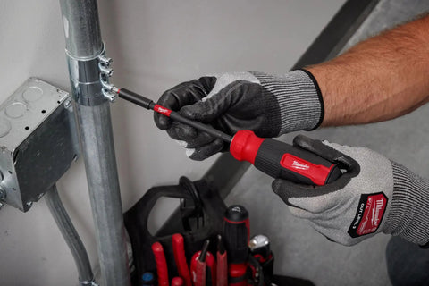 Person using Multi Bit Screwdriver Set With 14 Bits, Alloy76 Steel, Shockzone Torque Protection, in handle bit storage