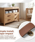 4 Pack Real Leather Cabinet Handles With Screws, brown leather pulls on a wooden dresser in a modern nursery.