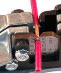 Close-up of Stripmaster Wire Stripper For 10-22 AWG stripping red wire with precision, heavy duty die cast zinc frame visible.