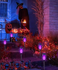 Solar Tiki Torch Lights Eight Piece Purple Outdoor Garden Decor With Realistic Flickering Flame for Halloween parties.