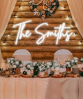 Custom Neon Signs For Wall Decor Personalize Large LED Neon Light Signs with 'The Smiths', floral centerpiece, wedding setting.