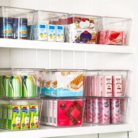 Hella Nifty Clear Stackable Storage Bins With Secure Snap Lids And Comfortable Side Handles And Large 6 Pack Real Deal Option For Kitchen Pantry Closet Fridge Under Sink Bathroom Organization filled with assorted snacks on shelving.
