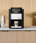 Creation 600 Single Serve Brewer on countertop, black color, brewing coffee cup with in-cup frothing tech, barista quality