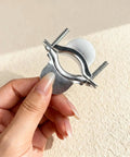 Close-up of hand holding a Two Piece Dryer Cord Strain Relief Clamp Kit for a heavy duty strong secure electrical connection.