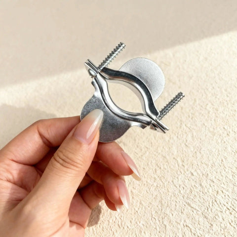 Close-up of hand holding a Two Piece Dryer Cord Strain Relief Clamp Kit for a heavy duty strong secure electrical connection.