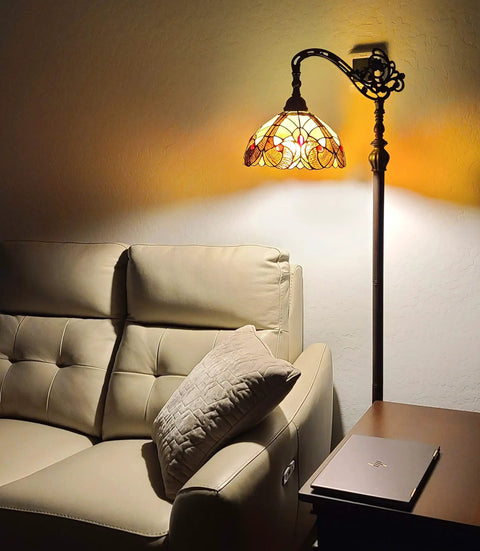 Tiffany Style Arched Floor Lamp With Stained Glass Shade And Jewel Accents, 62 Inch Tall Antique Brown Red Tan Traditional Reading Light next to sofa