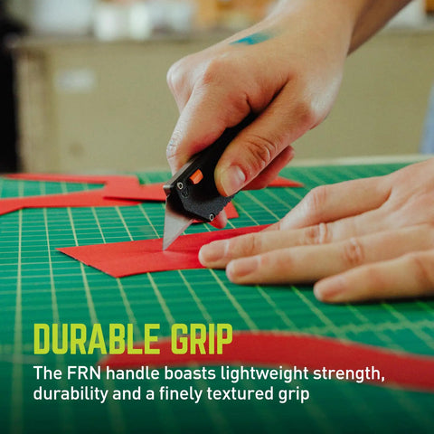 Keychain EDC Utility Knife With One Hand Opening And Four Locking Depth Positions, Durable FRN Grip, compact black cutter cutting red paper on mat