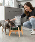 Top Shelf Bamboo Dog Food And Water Dispenser Stand For Medium Dogs Adjustable Pet Feeder Rack with dog drinking water.