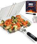 Stainless Steel Grill Basket For Outdoor Grilling filled with vegetables and chicken with removable anti-slip handle shown on a table.