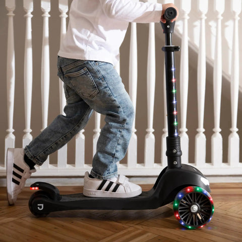 Three Wheel Light Up Kick Scooter For Kids Super Stable Design With Adjustable Handlebar LED Lights On Stem And Wheels No Tool Foldable Design Rear Foot Brake Beginner Friendly Red black scooter with child riding indoors