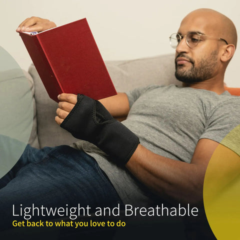 Nighttime Carpal Tunnel Wrist Brace With Cushioned Bead Palm Pillow worn by man reading on couch