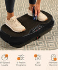 Person using Waver Mini Vibration Plate For Full Body Toning And Lymphatic Drainage With Remote And Bands, showing control panel.