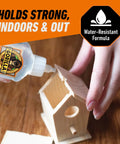 Person using Crystal Clear All Purpose Glue For Wood Metal Stone Ceramic Foam Glass And More Water Resistant Non Foaming Liquid Adhesive For Quick Bonds On DIY Projects 1.75 Ounce Bottle to assemble a wooden birdhouse.