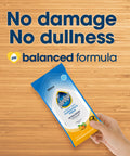 Hand holding pack of Multisurface Cleaning Wipes With PH Balanced Formula For Everyday Dust And Mess Cleanup on wooden surface