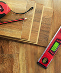 10 Inch Digital Level And Protractor With IP54 Inclinometer on wooden flooring next to tape measure and pencil