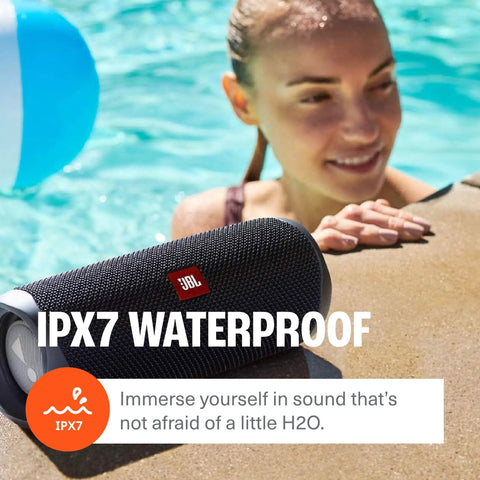 Flip 5 Dope Waterproof Portable Bluetooth Speaker With 12 Hours Of Playtime, IPX7 Waterproof, by poolside with person smiling.