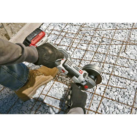 Professional 20V Max 4.5 Inch Angle Grinder cutting rebar on gravel surface with gloves and work boots.