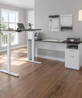 Heavy Hitter L Shaped Electric Standing Desk With Pretty Dang Smooth Motorized Lift And Scratch Resistant Deep Grey Top, modern workspace setup.