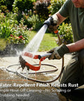 Man cleaning 63 Inch Stirrup Hoe Garden Tool With Adjustable Long Handle and 15 Degree Spring Steel Blade using a hose