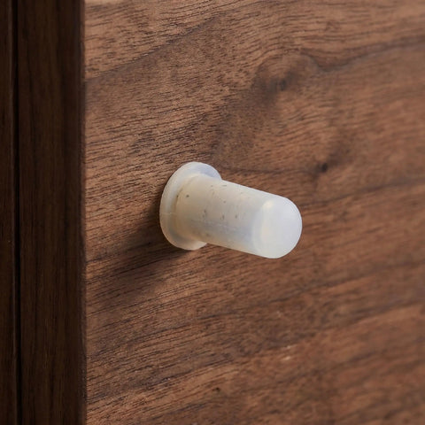 Close-up of Brass Shelf Pins With Rubber Covers 1/4 Inch for cabinets, showing secure, hidden minimalist shelf support.