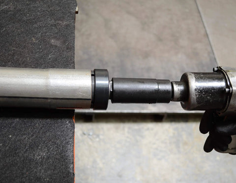 Astro Pneumatic exhaust pipe stretcher kit: metallic rod with black connector and clamp, side view