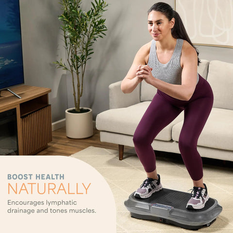 Woman exercising on Waver Vibration Plate Exercise Machine With High Intensity Full Body Vibration For Muscle Activation in living room