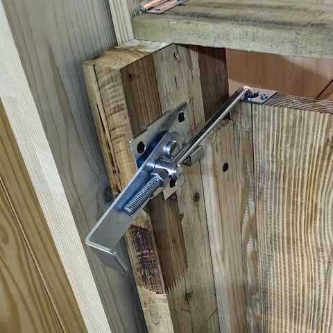 Close-up of Built Tough 2 Pack Zinc Barn Door Jamb Latch With Hook 7 Inch Cam Latch for secure locking on wooden door.