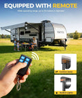Beefy 7500Lb Electric RV Tongue Jack With Remote Control shown operating with remote near RV at campsite.
