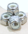 Close-up of 1/4-20 Nylon Insert Lock Nut Set Of 100 Stainless 304 Hex Lock Nuts With Nylon Insert on wood surface.