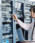 Technician working on 19 inch server cabinets with Four Pack 4U Blank Rack Panels For 19 Inch Server Cabinets Heavy Duty Metal Spacers.