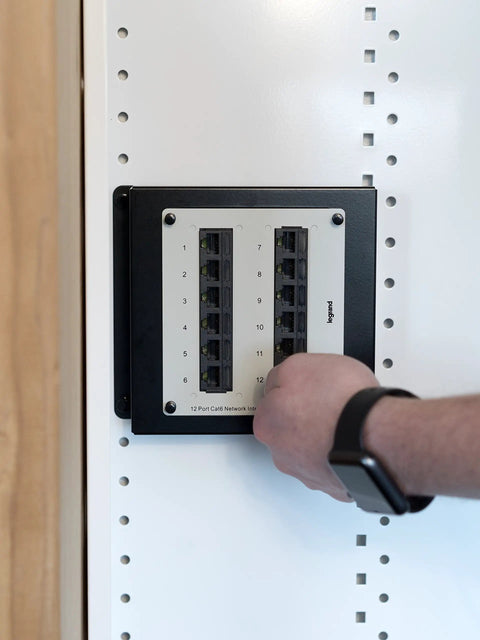 Hand adjusting cable in 12 Inch Cable Management In Wall Media Box For Home Networking Setup With 2.5 Inch Wire Openings