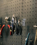 Space Saving Slatwall Hooks For Phone Accessories Silver Iron Wall Hangers holding tools on a pegboard display
