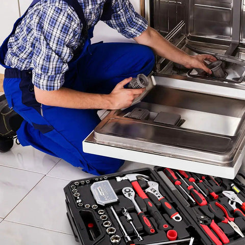 Man using 325 Piece Home Repair Tool Set With Drawer Toolbox Storage Case for dishwasher repair, tools spread out on floor.