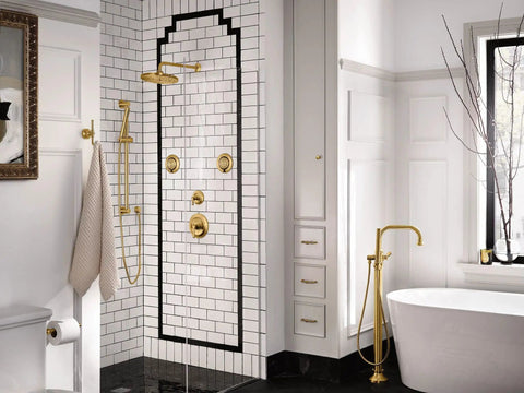 Elegant bathroom with gold fixtures, white tiles, and modern tub highlighting luxury shower design.
