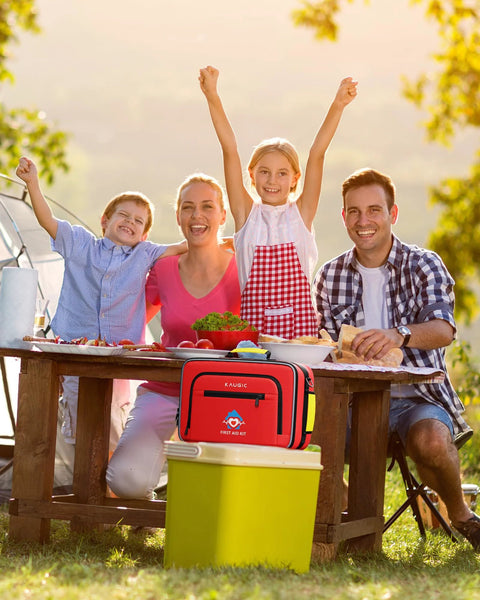 Red outdoor first aid kit on a picnic table; front view with zippered compartments.