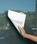 Spiff cleaning cloth being used to wipe a glass window with a white cloth