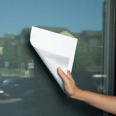 Spiff cleaning cloth being used to wipe a glass window with a white cloth