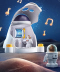 Hands On Rocket Space Toy Set For Kids Explore The Cosmos With A Spaceship Playset Space Shuttle And An Electric Drill Two Astronaut Figures STEM Take Apart Adventure Gift For 3 To 8 Year Old Boys And Girls with two astronaut figures on a playset under a starry sky with floating music notes.