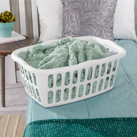 12 Pack Rectangular Laundry Basket With Handles, Heavy Duty Plastic Hamper, 1.5 Bushel Capacity, White Laundry Organizer For Bedroom Bathroom And Closet, BPA Free And Snag Proof Interior filled with green blanket on bed.