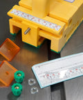 GRR Ripper Safe Rip Upgrade Kit For Table Saw Safety with yellow push block, orange cursor index, and measuring gauge on metal table.