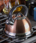 Copper finish Flintshire 1.75 Quart Stainless Steel Whistling Tea Kettle With Flip Up Spout Cover on stove