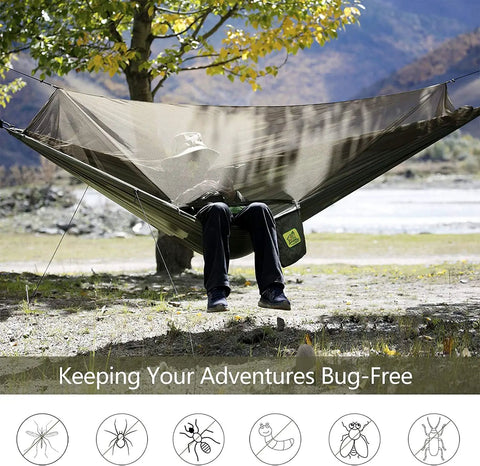 Person relaxing in Camping Hammock With Net And Rain Fly Portable Lightweight Outdoor Hammock Tent Kit in nature.