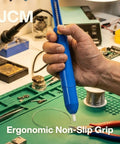 Hand holding Pro Grade Desoldering Pump Solder Sucker With High Power Vacuum Suction And Heat Resistant Nozzle For One Handed Operation Perfect For Electronics Repair And Soldering Irons above circuit board on workbench.