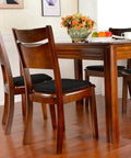 Four Pack Non Slip Dining Chair Cushions Set U Shaped Indoor Seat Pads 15 By 16 Inches Plush Breathable Fabric Black Comfy Durable Kitchen Chair Cushions With Anti Slip Grip on wooden chairs around a dining table.
