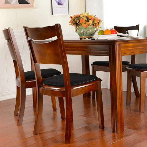 Four Pack Non Slip Dining Chair Cushions Set U Shaped Indoor Seat Pads 15 By 16 Inches Plush Breathable Fabric Black Comfy Durable Kitchen Chair Cushions With Anti Slip Grip on wooden chairs around a dining table.