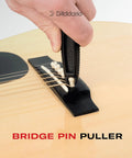Pro-Winder All-In-One Guitar Tool With String Winder Cutter Bridge Pin Puller close-up on acoustic guitar bridge