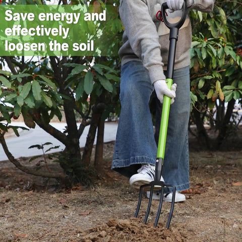 Person using Heavy Duty Garden Fork 45 Inch Pitch Fork With Steel Tines And Comfortable Y Grip For Spading Digging Compost And Lawn Bed Work Four Metal Tines For Tough Soil in a garden.